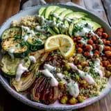Bright, sliced avocado and toasted pumpkin seeds add creamy crunch to a fresh Vegetable and Legume Bowl.