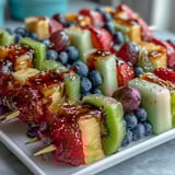 Bright and vibrant Rainbow Fruit Skewers with Honey Dip: juicy seasonal fruits threaded onto sticks, perfect for parties or healthy snacking, accompanied by a luscious honey-lemon yogurt sauce.