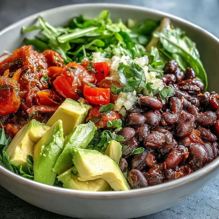 Hearty plant-based taco bowl showcasing seasoned black beans and crisp vegetable toppings.