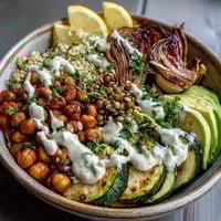 Roasted red bell peppers and broccoli top a warm quinoa base in this hearty Vegetable and Legume Bowl.